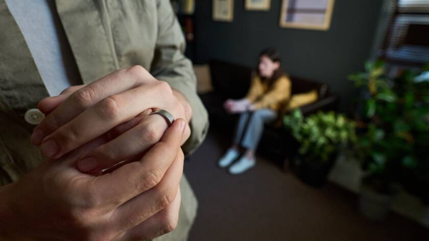 Man taking his ring off after filing a legal separation agreement in North Carolina