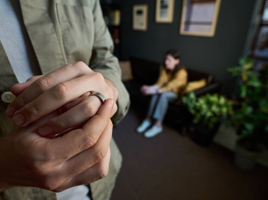 Man taking his ring off after filing a legal separation agreement in North Carolina